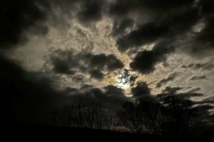 moonlight shining through dark clouds