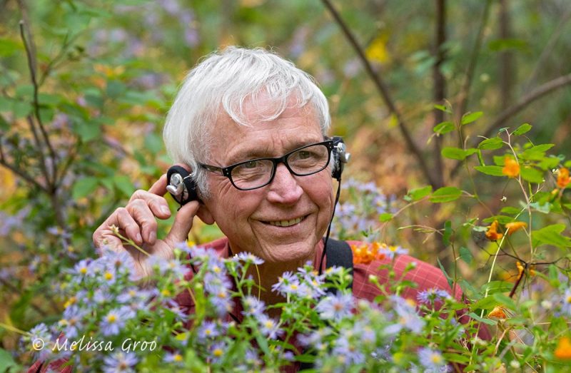 Lang among wildflowers with earphone on © Melissa Groo